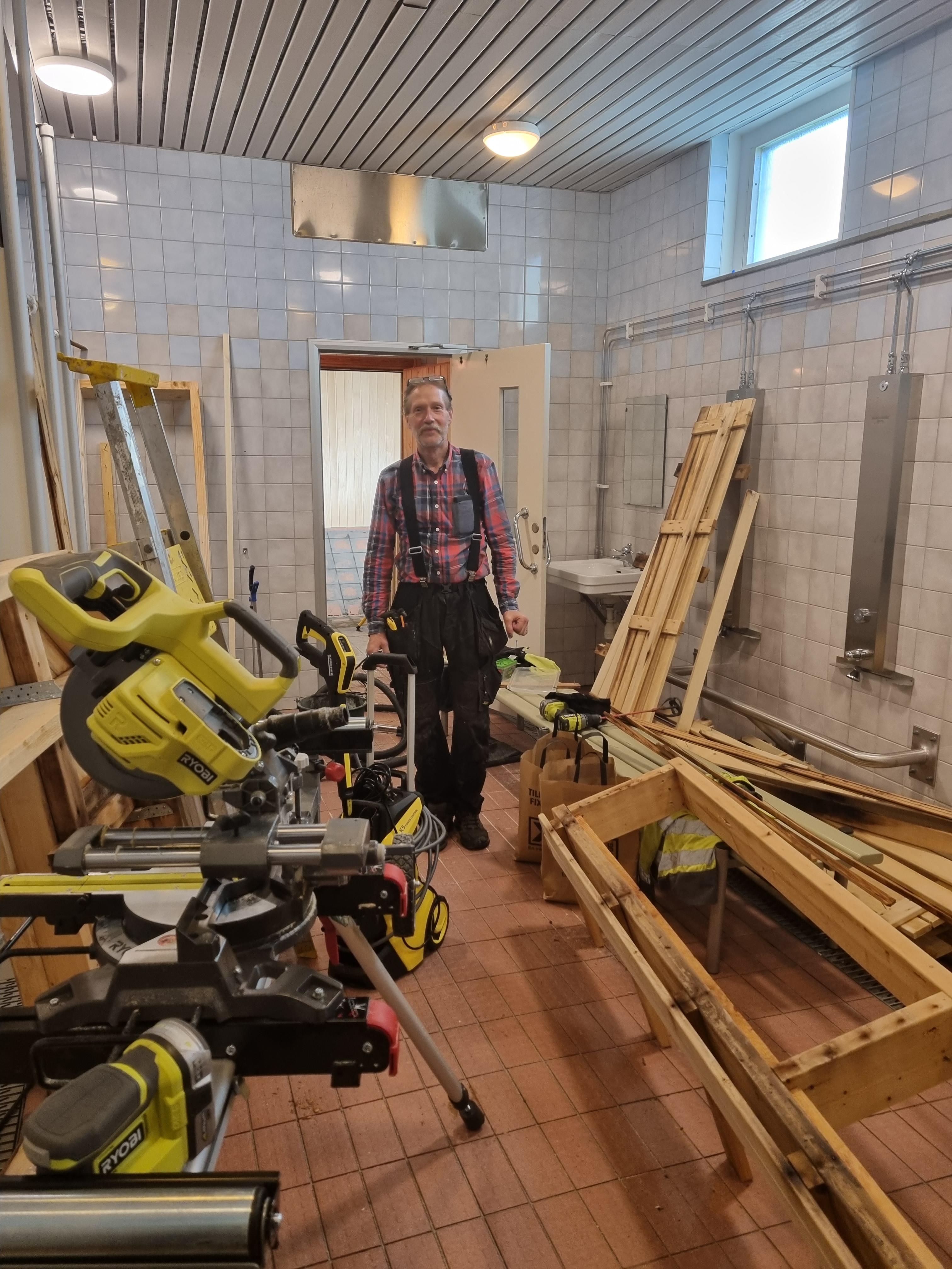 Viktor Forsmark, kommunsnickare, i färd att renovera herrarnas duschrum.